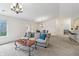 Open-concept living room with gray sofa and carpet, seamlessly connected to the dining area at 8910 Hunters Creek Dr # 207, Indianapolis, IN 46227
