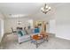 Bright living room with neutral walls, gray sofa, and open dining area at 8910 Hunters Creek Dr # 207, Indianapolis, IN 46227