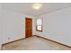 Bedroom featuring light-colored carpet, a wood door, and a window at 897 N Scott Dr, Greenwood, IN 46142