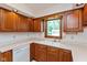Traditional kitchen with wood cabinets, double basin sink, and a bright window showcasing the outdoor view at 897 N Scott Dr, Greenwood, IN 46142