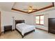 Bedroom featuring a tray ceiling, ceiling fan, and large window at 897 N Scott Dr, Greenwood, IN 46142