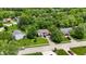 Charming home featuring a brick exterior, lush green lawn, mature trees, and an attached two-car garage at 9832 Scotch Pine Ln, Indianapolis, IN 46256