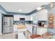 Well-lit kitchen featuring stainless steel appliances, blue accent wall and a central island for prep work at 9832 Scotch Pine Ln, Indianapolis, IN 46256