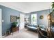 Cozy living room with comfortable daybed, vintage decor, and ample natural light creates a welcoming atmosphere at 9832 Scotch Pine Ln, Indianapolis, IN 46256