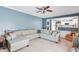 Cozy living room showcasing a comfortable sectional sofa, plush carpet, and adjacent kitchen at 9832 Scotch Pine Ln, Indianapolis, IN 46256