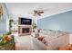 Comfortable living room with a brick fireplace, built-in bookshelves, and a large sectional sofa at 9832 Scotch Pine Ln, Indianapolis, IN 46256