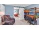Home office with dark furniture and a barn door leading to a living area, offering a blend of work and relaxation spaces at 9832 Scotch Pine Ln, Indianapolis, IN 46256