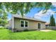 Spacious backyard featuring well maintained lawn, siding, and sliding glass door for entering the home at 10412 Cedar Dr, Fishers, IN 46037