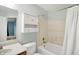 Bathroom featuring a shower-tub combo, single sink vanity, and mirrored medicine cabinet at 10412 Cedar Dr, Fishers, IN 46037