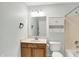 Bathroom featuring a shower-tub combo, single sink vanity, and mirrored medicine cabinet at 10412 Cedar Dr, Fishers, IN 46037