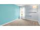 Bright bedroom with light blue walls, neutral carpet, shelving, and window at 10412 Cedar Dr, Fishers, IN 46037