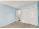 A bright bedroom with blue walls features carpeting and a closet for ample storage at 10412 Cedar Dr, Fishers, IN 46037