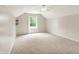 Bright bedroom with light-colored walls and carpet has a ceiling fan and a window letting in natural light at 10412 Cedar Dr, Fishers, IN 46037