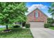Charming brick home with well-manicured lawn, attached garage, and beautiful landscaping at 10412 Cedar Dr, Fishers, IN 46037