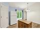 Charming kitchen with white appliances, wood island, and sliding doors to outdoor space at 10412 Cedar Dr, Fishers, IN 46037