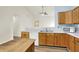 Well-lit kitchen with wood cabinets, white countertops, a microwave, and modern fixtures at 10412 Cedar Dr, Fishers, IN 46037