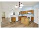 Bright kitchen featuring wood cabinets, modern appliances, and laminate flooring at 10412 Cedar Dr, Fishers, IN 46037
