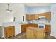 Bright kitchen featuring wood cabinets, modern appliances, and laminate flooring at 10412 Cedar Dr, Fishers, IN 46037