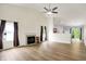 Inviting living room with fireplace, wood floors, and an open layout leading to the kitchen at 10412 Cedar Dr, Fishers, IN 46037