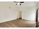 Spacious living room with wood floors, neutral walls, a ceiling fan, and great natural light at 10412 Cedar Dr, Fishers, IN 46037