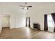 Bright living room with vaulted ceilings, wood floors, a fireplace, and large windows at 10412 Cedar Dr, Fishers, IN 46037