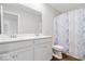 Bathroom boasts double sinks, a large mirror and a marble patterned shower curtain at 10419 Pronghorn Ln, Indianapolis, IN 46239