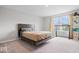 Light filled bedroom with a large window view, carpet, and a modern platform bed at 10419 Pronghorn Ln, Indianapolis, IN 46239