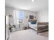 This charming bedroom features carpet and a large window view for ample natural light at 10419 Pronghorn Ln, Indianapolis, IN 46239