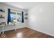 Bright bedroom features hardwood floors, a large window and adjacent shelving at 10419 Pronghorn Ln, Indianapolis, IN 46239