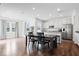 Bright dining area with dark wood floors, white walls, stainless steel appliances, and white cabinets at 10419 Pronghorn Ln, Indianapolis, IN 46239