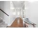 Bright hallway with wood floors, white walls, staircase with gray carpet, and modern decor at 10419 Pronghorn Ln, Indianapolis, IN 46239