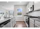 Well-lit kitchen with stainless steel appliances, white cabinets, wood flooring, and an open layout at 10419 Pronghorn Ln, Indianapolis, IN 46239