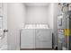Laundry room featuring a white washer and dryer and hot water tank at 10419 Pronghorn Ln, Indianapolis, IN 46239