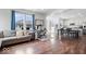 Spacious living room with wood floors, white walls, large windows, and an open layout leading to the dining area at 10419 Pronghorn Ln, Indianapolis, IN 46239