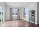 Bright living room with wood floors, white walls, large windows, sliding glass doors, and modern décor at 10419 Pronghorn Ln, Indianapolis, IN 46239
