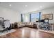 Bright living room with wood floors, white walls, large windows, comfortable seating, and modern décor at 10419 Pronghorn Ln, Indianapolis, IN 46239