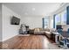 Bright living room with wood floors, white walls, large windows, comfortable seating, and modern décor at 10419 Pronghorn Ln, Indianapolis, IN 46239