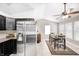 Bright dining area with large windows, modern ceiling fan, and tile flooring next to a stainless refrigerator at 10763 Zimmerman Ln, Indianapolis, IN 46231