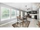 The dining area is spacious with a view to the kitchen, fireplace, and backyard at 10763 Zimmerman Ln, Indianapolis, IN 46231