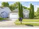Charming single Gathering home featuring a manicured lawn and an attached two-car garage at 10763 Zimmerman Ln, Indianapolis, IN 46231