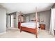 Well-lit primary bedroom features a large bed, side tables, and access to the bathroom at 10763 Zimmerman Ln, Indianapolis, IN 46231