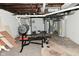 Unfinished basement area featuring a weight bench and some utilities at 122 E 27Th St, Indianapolis, IN 46205