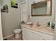 Bathroom featuring white cabinets, decorative countertop, large mirror, tiled floors and ample lighting at 122 E 27Th St, Indianapolis, IN 46205