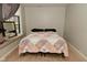 Comfortable bedroom with neutral walls and a quilted bedspread, natural lighting and a mirror hanging on the wall at 122 E 27Th St, Indianapolis, IN 46205