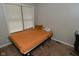 Comfortable bedroom with carpeted floors, a window with blinds, simple decor and light colored walls at 122 E 27Th St, Indianapolis, IN 46205