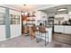 Kitchen featuring white cabinets, laminate countertop, decorative shelving and bar stool seating at 122 E 27Th St, Indianapolis, IN 46205