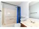 This bathroom has a shower with blue curtains, a toilet, a sink, and a mirror at 12612 Majestic Way, Fishers, IN 46037