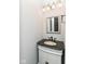 Small bathroom with granite countertop, white vanity and decorative mirror at 12612 Majestic Way, Fishers, IN 46037