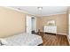 This cozy bedroom features wood floors, neutral walls, and a dresser with a mirror at 12612 Majestic Way, Fishers, IN 46037
