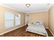 This bedroom has beautiful wood floors, neutral-colored walls, and a view of the backyard at 12612 Majestic Way, Fishers, IN 46037